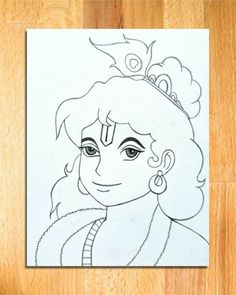 a drawing of a woman wearing a tiara on top of a wooden table next to a piece of paper