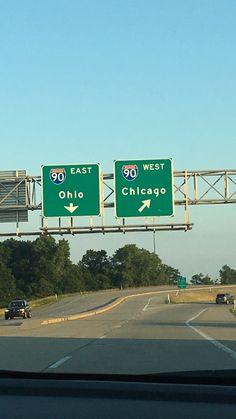 two highway signs on the side of an interstate