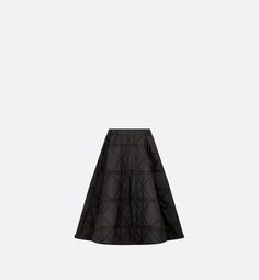 New this season, the skirt honors House heritage with the hallmark Macrocannage motif. Crafted in black quilted fabric, it is distinguished by a set of pleats that create generous volume and an ideal drape. The skirt may be worn with the matching sweatshirt to complete the look.. Black Accordion Pleats Voluminous Skirt, Black Voluminous Skirt With Accordion Pleats, Black Luxury Long Skirt, Luxury Black Long Skirt, Luxury Long Black Skirt, Luxury Black Skirt, Denim Swimsuit, Dior Star, Blanket Poncho