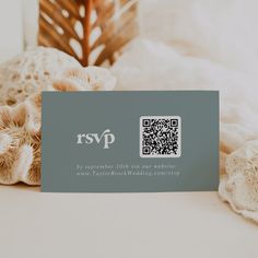 a close up of a business card on a bed with mushrooms and other items in the background