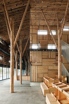 an empty building with wooden beams and benches