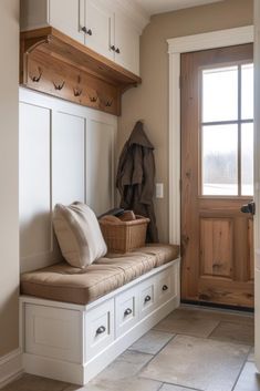 a wooden bench sitting under a window next to a door