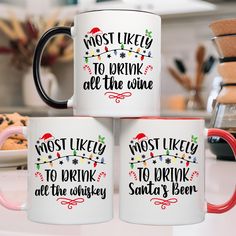 three coffee mugs sitting on top of a counter next to cookies and other items