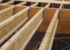 the inside of a house being built with plywood and wood framing on the floor