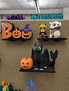 halloween decorations are displayed on shelves in an office