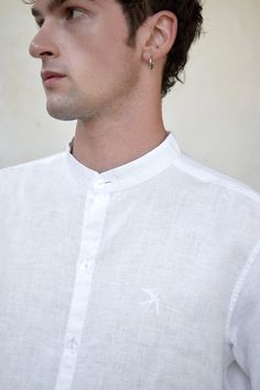 Perfect linen shirt with decorative embroidery "Swallow" could be a formal outfit and also free style. The shirt suit for men who appreciates sophistication and minimalism.  Stand-up collar Length: 70 cm Straight cut, oversized Dropped shoulder seam Long sleeve with cuff, small embroidery ""Swallow"" in white color on the left side Buttons made from seashells  Made of 100% natural linen, Oeko-Tex certified, free of harmful chemicals. It keeps the temperature of the body + -4 degrees, these cloth Classic Summer Shirt With Stand Collar, Elegant White Linen Shirt, Formal White Linen Shirt, White Linen Formal Shirt, Classic White Shirt With Stand Collar, Linen White Shirt, Men Linen Shirt, Office Shirt, White Shirt Men