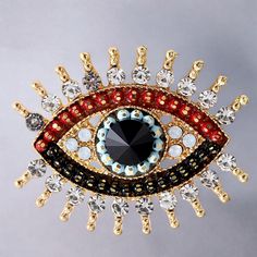 This brooch showcases a mesmerizing Evil Eye design, meticulously crafted with sparkling crystals in vibrant shades of red, black, blue, and white. The gold-toned setting adds a touch of luxury. 🧿What Is Included:🧿 - 1 x Brooch 🧿Size: 🧿 - 3.9x3.2cm 🧿Key Features:🧿 - Believed to offer protection from the evil eye and negative energy - Makes a bold and stylish statement piece - Perfect for adding a unique touch to jackets, scarves, bags, or hats - Thoughtful and meaningful gift for loved one Elegant Black Evil Eye Jewelry, Luxury Spiritual Evil Eye Jewelry, Bohemian Red Evil Eye Jewelry, Evil Eye Brooch, Evil Eye Amulet Jewelry, Eye Brooch, Evil Eye Design, Protection Amulet, Eye Design