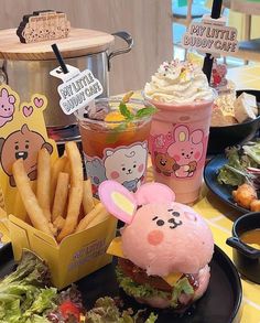 a table topped with plates of food and drinks