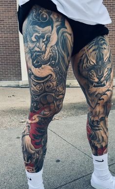 a man with tattoos on his legs and leggings