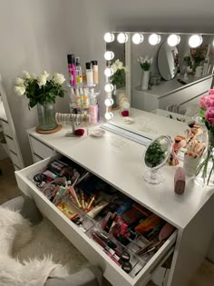 a vanity with flowers and makeup on it