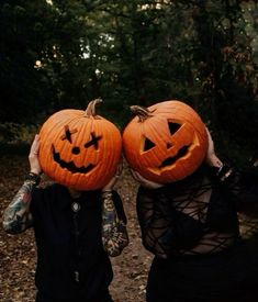 two people with pumpkins on their heads