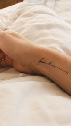 a person's foot with a tattoo on it that reads, i love you