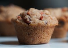 three muffins sitting next to each other on a white counter top with blurry background