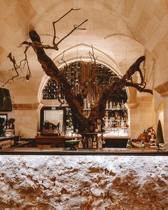 the bar is decorated with branches and bottles