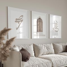 a living room filled with white furniture and pictures on the wall above it's coffee table