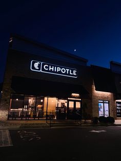 a chipotle store lit up at night