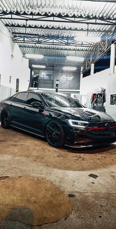 a black sports car parked in a garage