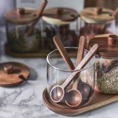 Beautiful acacia wood meets up with glass for a set of food storage jars that are both useful and decorativeFrom spices and seasonings to coffee beans and loose leaf teakeep the items you're always reaching for at the ready in a counter worthy container set that's naturally aestheticStarting with a richwarm toned acacia wood traythree glass jars sit nicely on it and hold over a cup worth of contents per jarEach carved and hand polished acacia wooden spoon sits in the glass container, Handmade Wooden Spoons, Spice Jar Set, Kitchen Containers, Spice Containers, Spice Jar, Glass Storage Jars, Food Jar