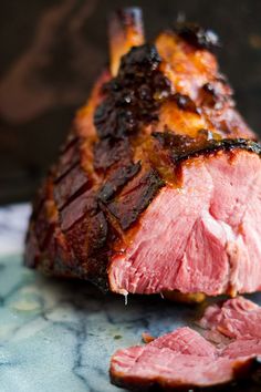 a piece of meat sitting on top of a table next to another piece of meat