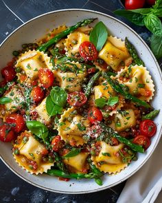 a bowl filled with pasta and vegetables on top of a table