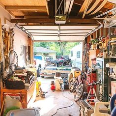 a garage filled with lots of different types of bikes and tools on the shelves,