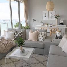 a living room filled with lots of furniture and decor on top of a white rug