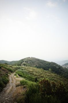 a dirt road going up the side of a hill