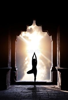 a person doing yoga in front of the sun