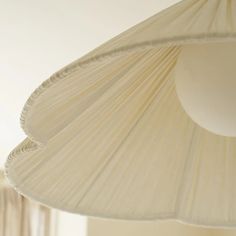 a white lamp hanging from the ceiling in a room