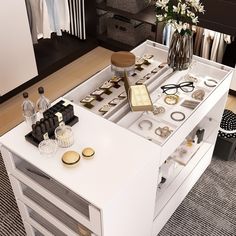 a white table topped with lots of drawers and items on top of each other in a room