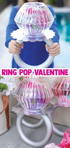 the ring pop valentine is in front of a pool with pink and white flowers on it