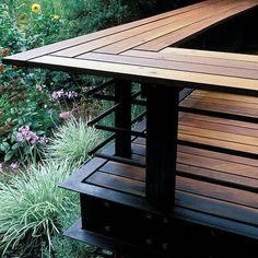 a wooden bench sitting in the middle of a garden