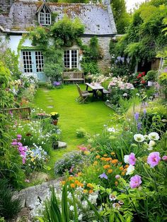 the garden is full of colorful flowers and greenery, including an old - fashioned house