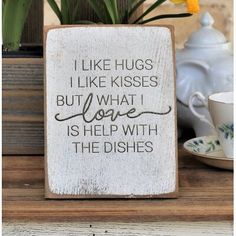 a wooden sign that says i like hugs but what i love is help with the dishes