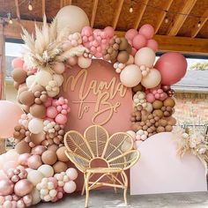 a pink and gold balloon arch with the words happy birthday on it, surrounded by balloons