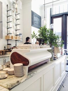 a counter top with plates and cups on it