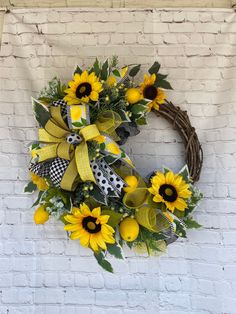 a sunflower wreath on a brick wall