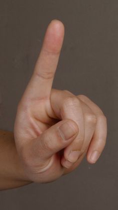 a person's hand is pointing to the left with their index finger in front of them