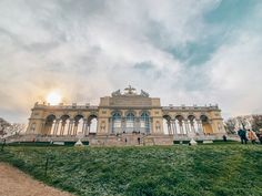 a large building sitting on top of a lush green field