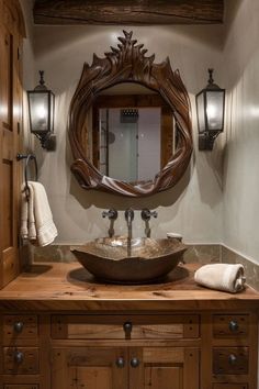 a bathroom sink sitting under a mirror next to a wooden cabinet and wall mounted lights