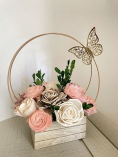 a wooden box with flowers and a butterfly on it