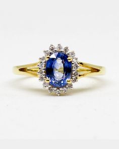 THE CEYLON BLUE SAPPHIRE 1 PEC. – 1 . 24 CARATS. WITH THE DIAMONDS 18 PECS. – 0 . 18 CARAT. 18 K.- 750 YELLOW GOLD RING 3 . 30 GRAMS. WIDTH 1 . 10 X LENGTH 2 . 10 CM. ANY SIZE IS AVAILABLE PLEASE CONTACT FOR MORE INFORMATION