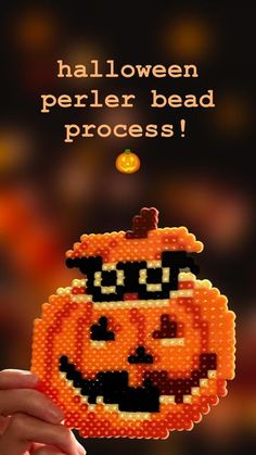 someone is holding up a beaded pumpkin with the words halloween perler bead process