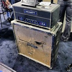 two amps are stacked on top of each other in front of a group of people