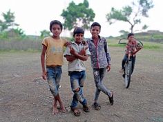 three young boys are playing with their bikes