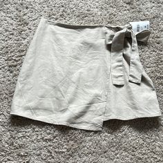 Super Cute Skirt For Summer/Fall! Tan Linen Like Material Trendy Mini Wrap Skirt For Day Out, Trendy Mini Wrap Skirt For Spring, Chic Mini Skort With Tie Waist, Casual Mini Wrap Skirt For Day Out, Trendy Skort For Brunch, Trendy Mini Skirt For Brunch, Beige Tie Waist Skirt For Spring, Spring Mini Skirt With Tie Waist, Spring Beige Tie Waist Skirt