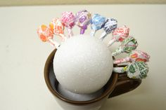 a cup filled with candy on top of a table