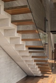 the stairs are made of concrete and wood