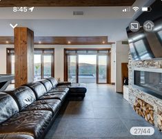 a living room filled with furniture and a flat screen tv mounted to the side of a wall