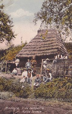 this is an old photo of people and horses in front of a small house with a thatched roof